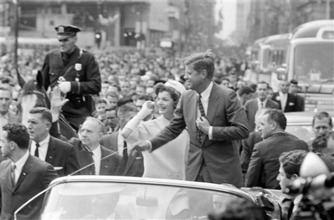 Sen. John F. Kennedy, Democratic presidential candidate, and his wife, Jacqueline, pause to talk to crowd as they pass through the Wall Street area en route to City Hall in New York, Oct. 19, 1960. As Kennedy talked the crowd surged toward his car. At Mayor Wagner's suggestion, Sen. Kennedy spoke but briefly and motorcade proceeded up Broadway from City Hall. (AP Photo)