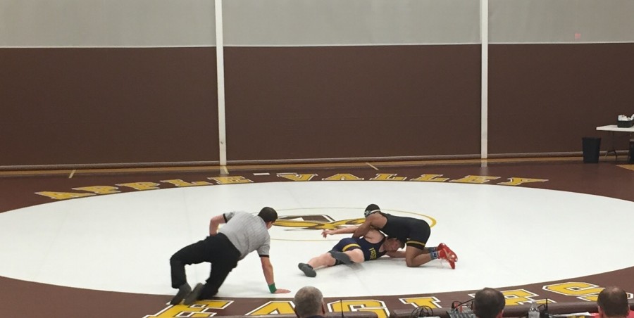 Senior captain Mark Hall takes down his opponent in his match Friday night.