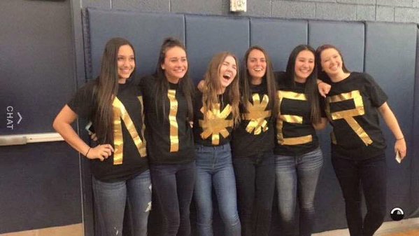 Girls from Desert Vista High School posing for a picture while spelling out a racial slur with their shirts