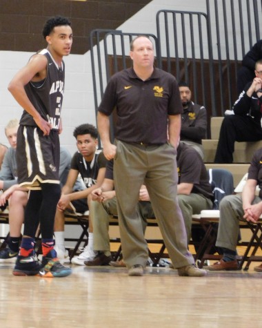 Tre Jones chats with coach Zach Goring during a break in the action against Shakopee