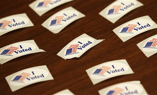 I Voted stickers sit on a table during early voting for the Nov. 6th election, Wednesday, Oct. 24, 2012, at the Davenport Public Library in Davenport, Iowa. Early voting for the Nov. 6th election likely will set an Iowa record, as presidential candidates seek to lock-in votes in the battleground state. (AP Photo/Charlie Neibergall)