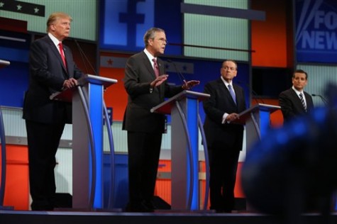 Republican presidential candidates from left, Donald Trump, Jeb Bush, Mike Huckabee and Ted Cruz take the stage for the first Republican presidential debate at the Quicken Loans Arena Thursday, Aug. 6, 2015, in Cleveland. (AP Photo/Andrew Harnik)