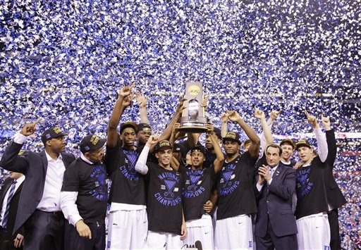 Duke holds up the national championship trophy from last year's NCAA tournament.