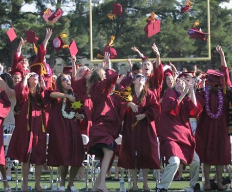 Graduates of Menlo Atheron High School throw their caps in the air at the end of graduation ceremonies in Menlo Park, California.