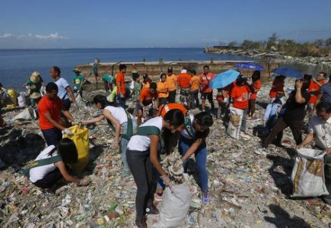 Environmentalists conduct a coastal clean up to mark World Earth Day Friday, April 22, 2016 at a bird sanctuary known as "Freedom Island" in suburban Las Pinas city south of Manila, Philippines. (AP Photo/Bullit Marquez)