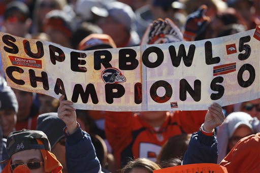 A Denver Broncos fan holds up sign during a rally following a parade for the NFL football Super Bowl champions.