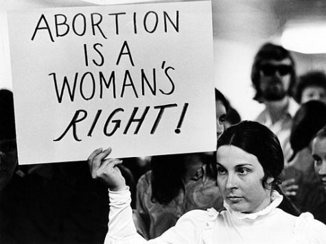 A young woman holds a sign demanding a woman's right to abortion at a demonstration to protest the closing of a Madison abortion clinic in Madison, Wis., April 20, 1971. The Midwest Medical Center was closed after authorities said more than 900 abortions had been performed at the facility in violation of the state's abortion laws. The protest is held at the Dade County building. (AP Photo)