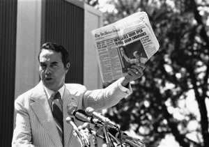 Republican vice presidential candidate Sen. Robert Dole holds up a newspaper during a rally in Des Moines, Iowa, August 26, 1976. 