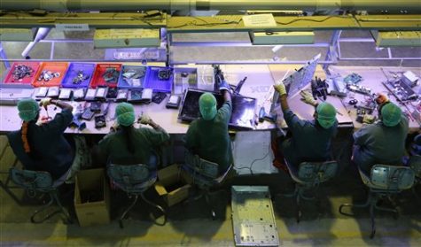 Indian women workers dismantle electronic waste at E-Parisaraa. (AP Photo/Aijaz Rahi)