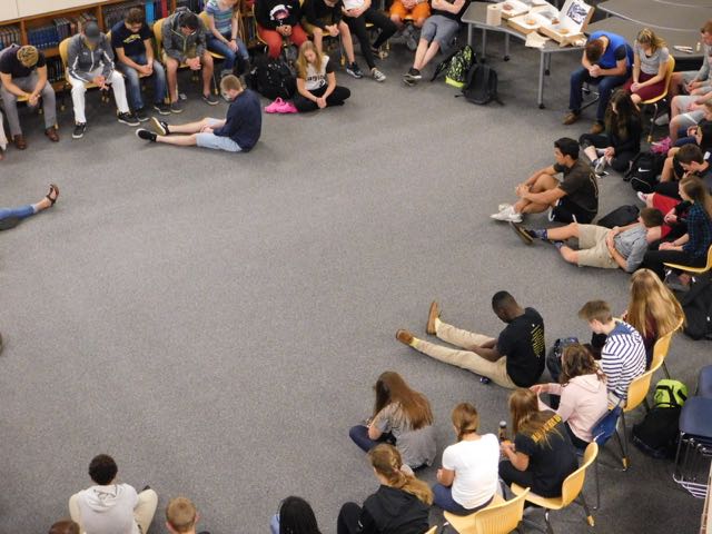 Students pray at the start of the Bible study meeting.