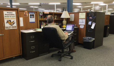 Mr. Brewer works at his desk after school.