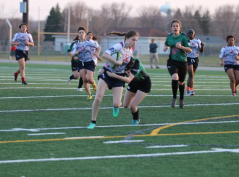 Megan Navratil, player for Eagan Sentinels Rugby club tackling an Armstrong player