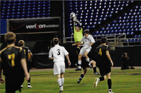 Tim Van Beck going up for a save. Van Beck holds school records for save percentage and career shutouts.