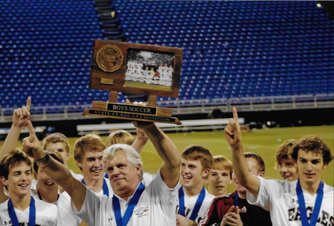 Coach Chuck Scanlon holds up the state championship trophy in 2009.