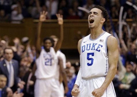 Duke's Tyus Jones (5) and Amile Jefferson (21), rear, react following Jones' basket against Notre Dame during the first half of an NCAA college basketball game in Durham, N.C., Saturday, Feb. 7, 2015. Duke won 90-60. (AP Photo/Gerry Broome)