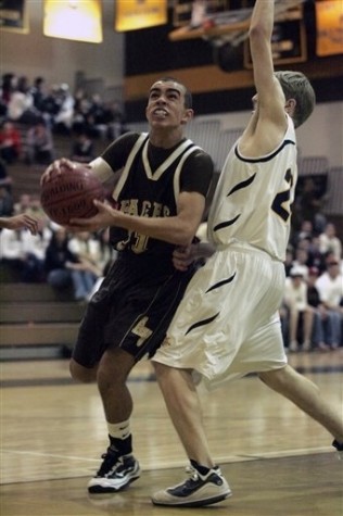 In a photo made March 2, 2010, Apple Valley High School starting point guard Tyus Jones, left, an eighth grade stand-out, drives to the basket against Bloomington Kennedy guard Jonathan Blumberg during a basketball game in Apple Valley, Minn. (AP Photo/Paul Battaglia)