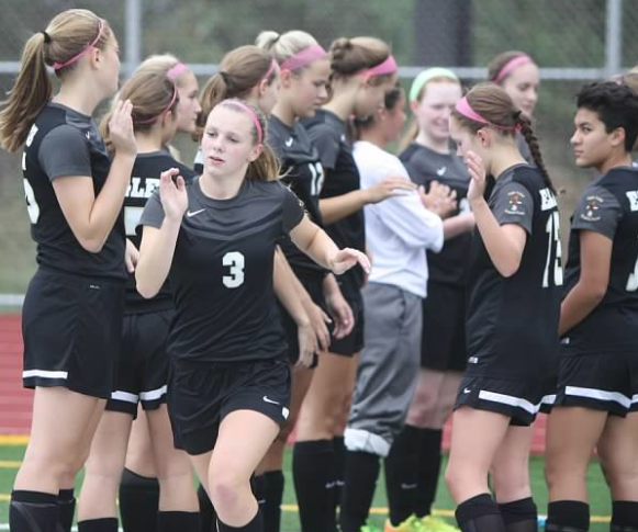 Sidney Bethke and the rest of the girls soccer team going through player intros.