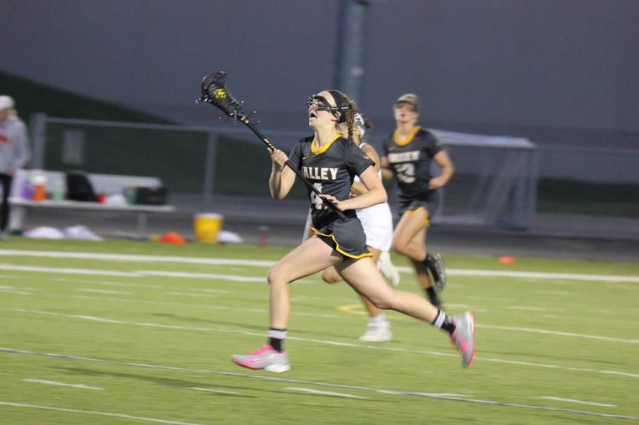 Katie Moynihan surges ahead on offense during a varsity lacrosse game.