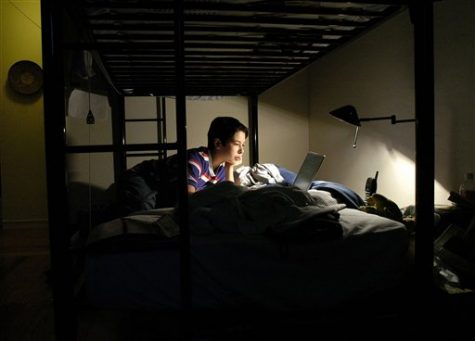 A boy plays games and does homework on his laptop (AP Photo/Noah Berger/File)