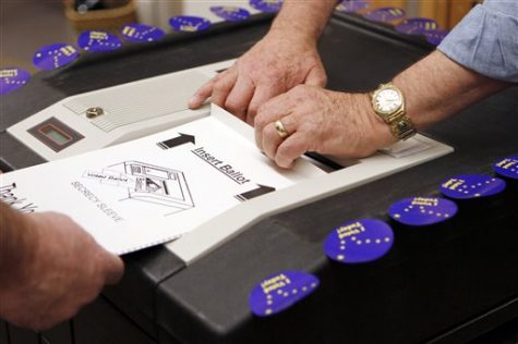 A ballot is inserted into a voting machine Tuesday, Nov. 2, 2010, in Girdwood, Alaska. (AP Photo/Ben Margot)