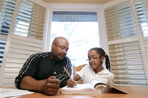  Roger Witherspoon helps his daughter, Gabrielle, 9, with her homework in Nashville, Tenn. Tennessee is one of only a few states that has passed laws creating evaluations or contracts that put helping with homework or attending teacher conferences into writing. (AP Photo/Mark Humphrey)