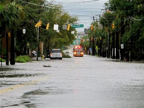 A firetruck drives through a flooded street in the hospital district of Charleston, S.C., on Saturday, Oct. 8, 2016 after Hurricane Matthew passed through. Most of the damage in the city was downed trees and street flooding and officials said 100 streets were closed because of high water. (AP Photo/Bruce Smith)