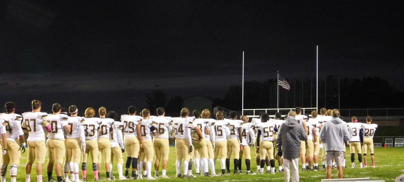 The teams line up for the National Anthem prior to the game.