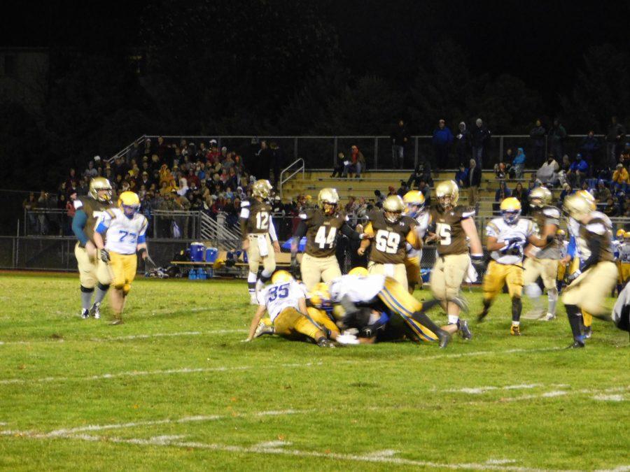 Players dive on a loose ball in the fourth quarter.