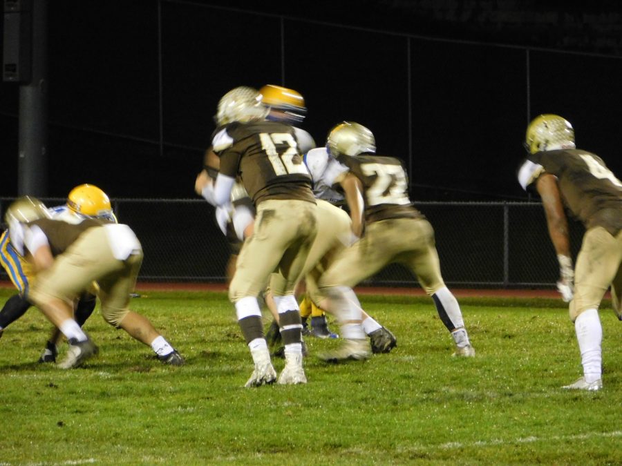 Noah Sanders leads the offense on a drive into Hastings territory.