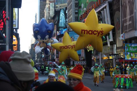 Macy's yellow star balloons lead the way through downtown New York City.