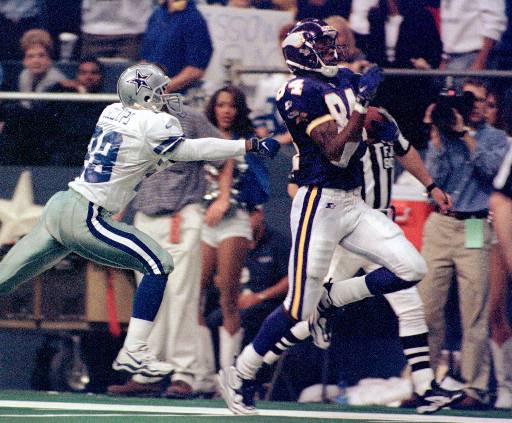 Minnesota Vikings wide receiver Randy Moss (84) runs for a 56-yard touchdown in the third quarter as Dallas Cowboys cornerback Terry Billups gives chase Thursday, Nov. 26, 1998, in Irving, Texas. Minnesota won 46-36. (AP Photo/Tim Sharp)