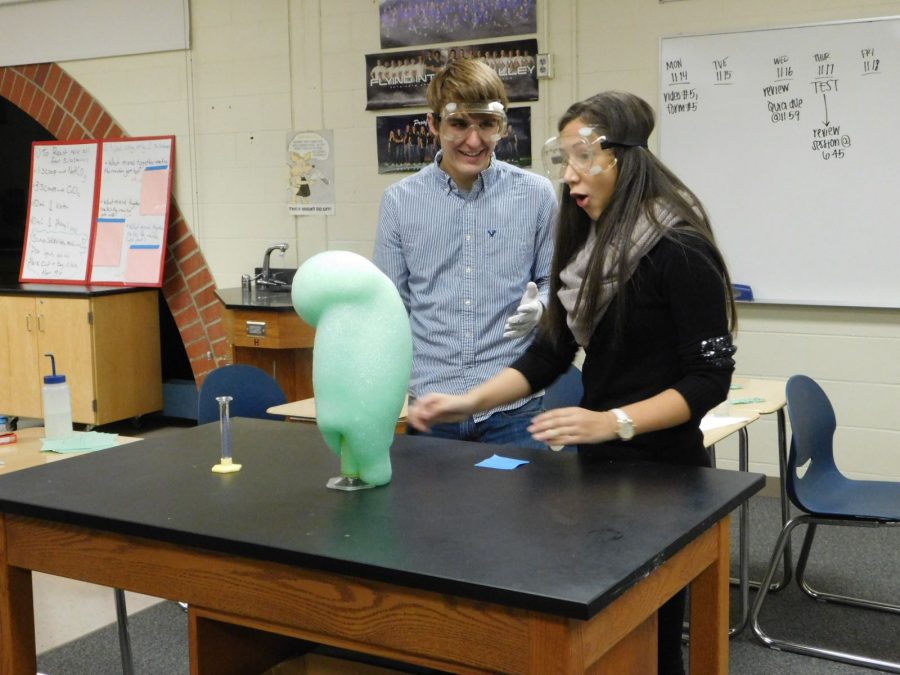 Seniors Henry Dikeman and Kelly Zafra practice their demo in the chemistry room.