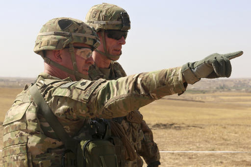 This Oct. 10, 2016 photo released by the U.S. Army shows U.S. Army Lt. Col. Ed Matthaidess, commander, left, Task Force Falcon, outlining areas of an Iraqi security forces tactical assembly area to U.S. Army Maj. Gen. Gary J. Volesky, commander, Combined Joint Forces Land Component Command – Operation Inherent Resolve, in northern Iraq, prior to the start of the Mosul offensive. The U.S. has just as much to gain from the operation to recapture Mosul as the Iraqis themselves. Since 2014, the U.S. has provided airstrikes and advise-and-assist operations to put the beleaguered Iraqi military back on its feet after the Islamic State group gutted it of weapons, supplies and soldiers during its blitzkrieg across Iraq and Syria.(U.S. Army photo by Sgt. 1st Class R.W. Lemmons IV via AP)