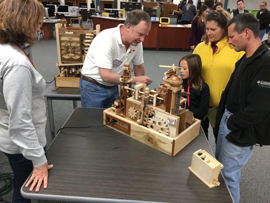 Kevin Dahlke from Red Shed Supply shows students an interactive display.