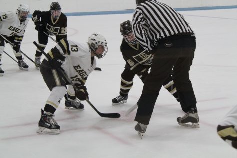 Amy Breckner facing off for the puck.