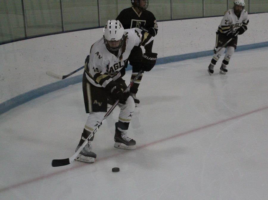 Emma Vogelgesang passing the puck after a defensive play.