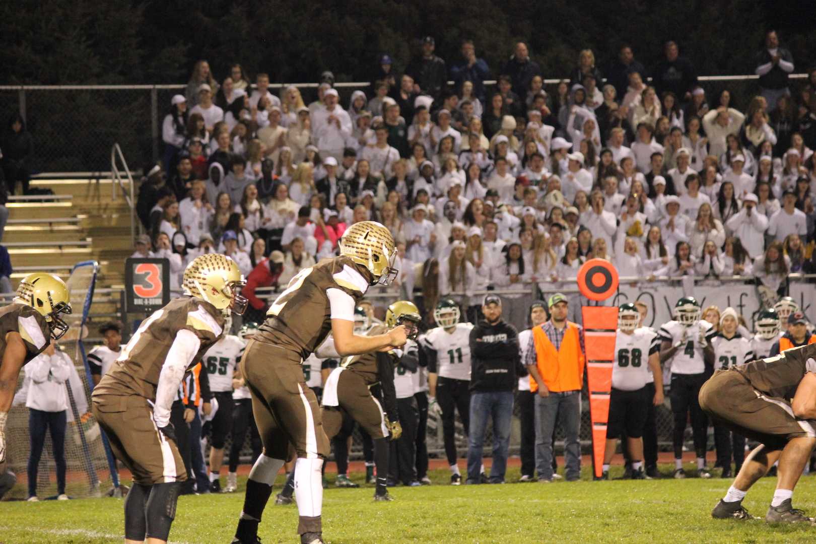 Noah Sanders prepares to receive the snap as the Park High School student section looks on.