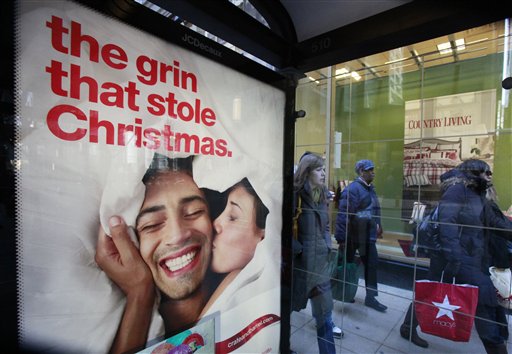 Shoppers walk past a Christmas advertisement outside Sears Friday, Nov. 27, 2009, in downtown Chicago as consumers around the nation crowded stores and malls on Black Friday, the traditional start of the holiday shopping season. (AP Photo/Charles Rex Arbogast)