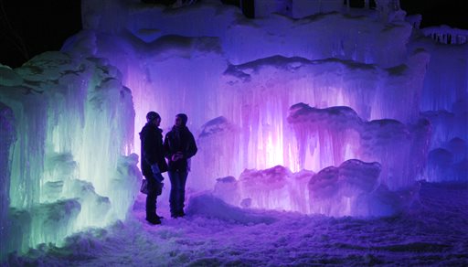 In this photo taken Jan. 8, 2014 patrons tour an ice castle at the base of the Loon Mountain ski resort in Lincoln, N.H. 