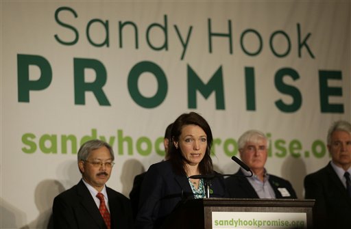 Nicole Hockley, center, speaks in front of San Francisco Mayor Ed Lee, rear from left, Ron Conway of SV Angel, and San Francisco District Attorney George Gascon at a Sandy Hook Promise news conference in San Francisco, Thursday, March 14, 2013. Families of children killed in the Sandy Hook Elementary School shooting on Dec.14, 2012, in Newton, Conn., joined San Francisco Bay Area families of shooting victims and technology and political leaders to announce the Sandy Hook Promise Innovation Initiative, an initiative to prevent future gun violence. Hockley's son Dylan was killed in the Sandy Hook Elementary School shooting. (AP Photo/Jeff Chiu)