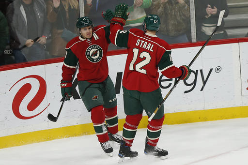 Minnesota Wild's Zach Parise celebrates with teammate Eric Staal (12) after Parise scored a goal.