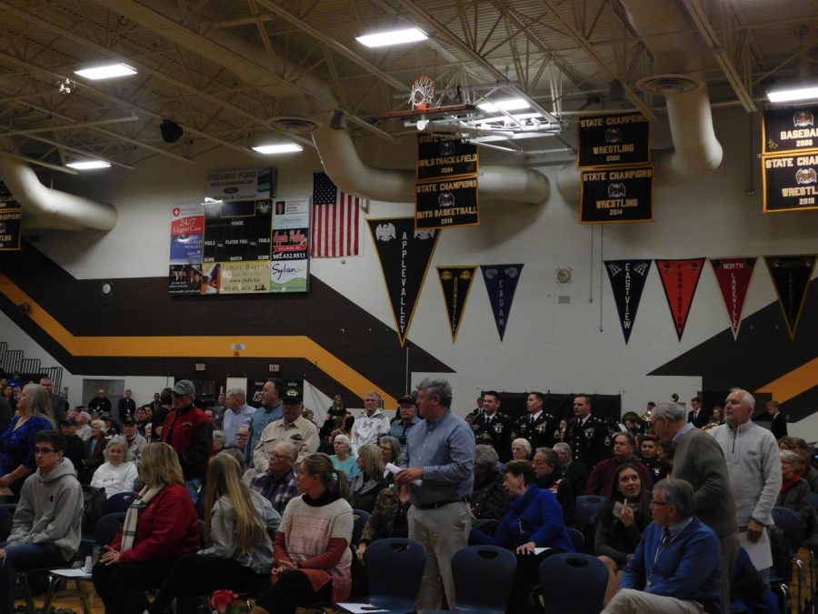 Veterans stand as they hear their theme song from the "Armed Forces Salute," performed by the AVHS Wind Ensemble.