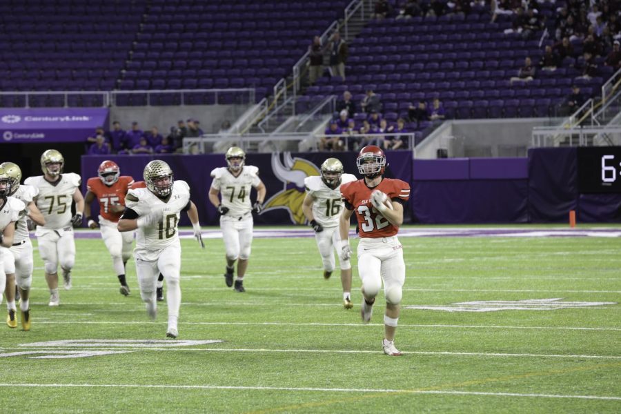 Elk River running back Jon Suchy sprints away from the Apple Valley defense.