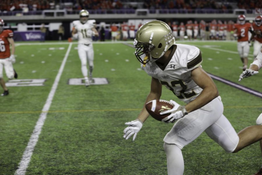 Senior Justin Firpo runs after the catch.