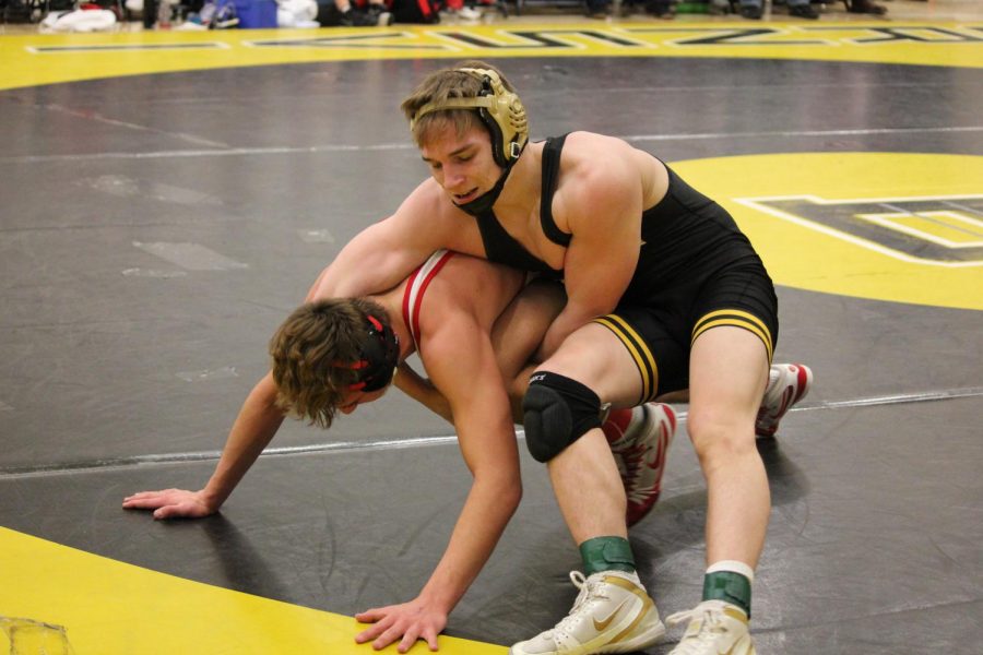 Senior Brady Gross battles a Lakeville North opponent in the first round of the team section tournament.